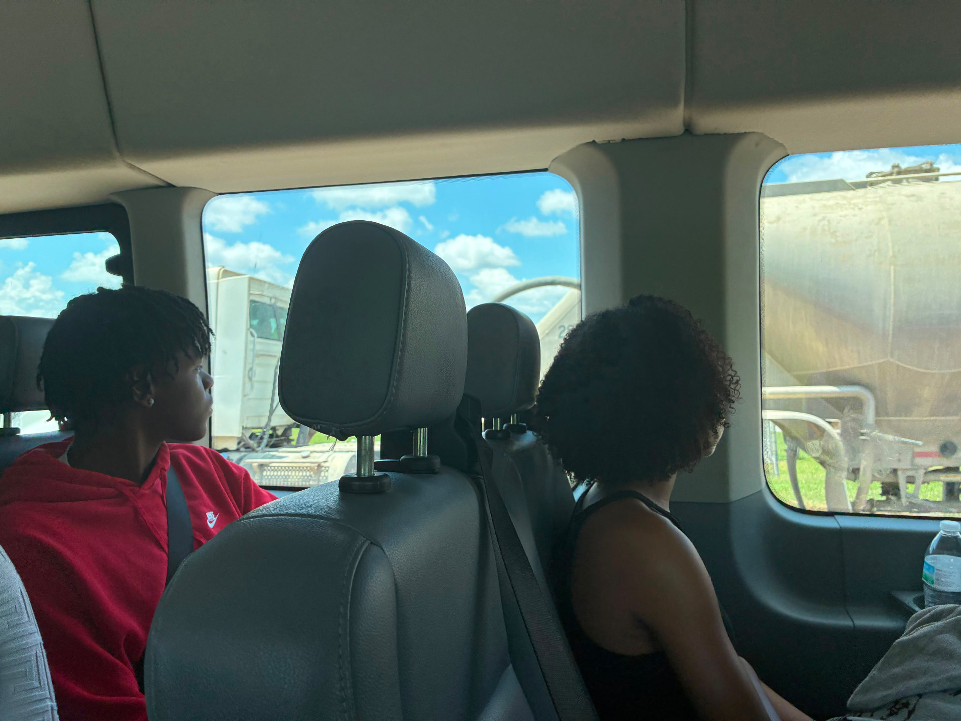 Young scientists observing equipment during a field trip